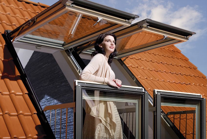 Innovative, large roof window in which the open sashes create a balcony FAKRO